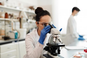 cancer researcher with microscope