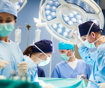 Surgeons operating on patient