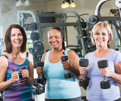 three women holding weights